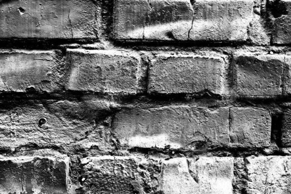 Textura de uma parede de tijolo com fendas e arranhões que podem usar-se como um contexto — Fotografia de Stock