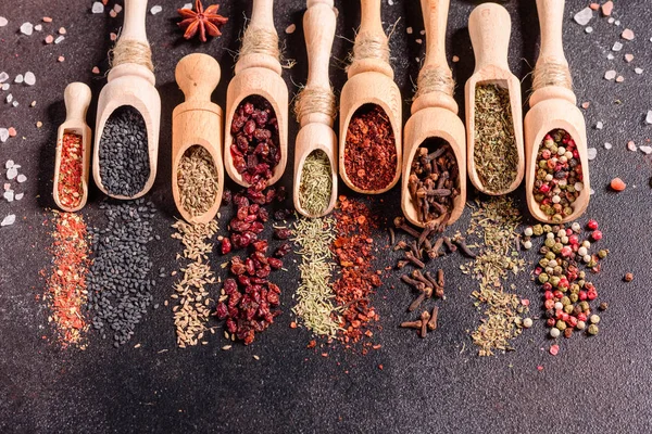 Spices and herbs over black stone background. Top view with free space for menu or recipes — Stock Photo, Image