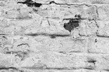 Çatlakları ve çizikleri olan tuğla duvar dokusu arka plan olarak kullanılabilir.