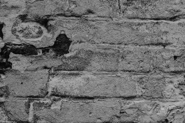 Textura de una pared de ladrillo con grietas y arañazos que se puede utilizar como fondo —  Fotos de Stock