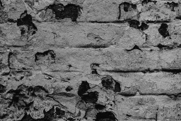 Υφή ενός τοίχου από τούβλα με ρωγμές και γρατσουνιές που μπορεί να χρησιμοποιηθεί ως φόντο — Φωτογραφία Αρχείου