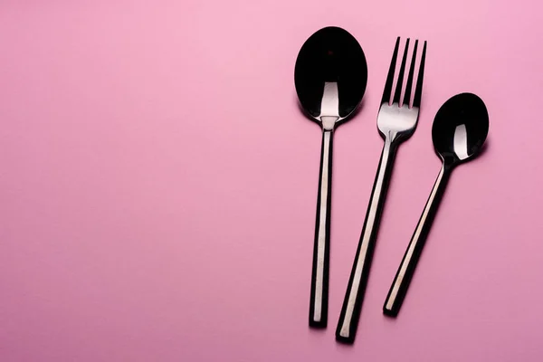 Metal Lepel en vork Geïsoleerd op roze achtergrond. Servies klaar voor de maaltijd — Stockfoto