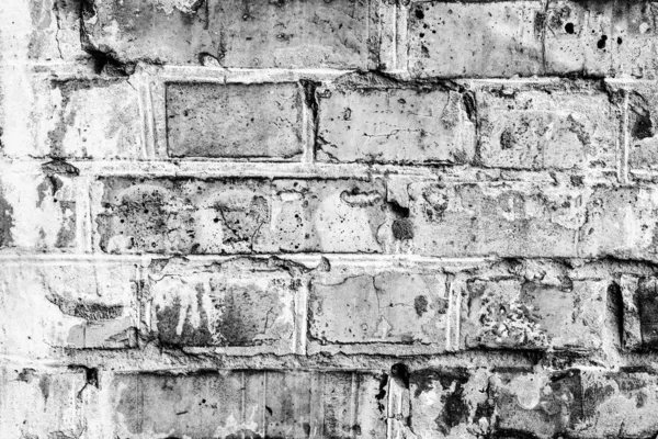 Textura de una pared de ladrillo con grietas y arañazos que se puede utilizar como fondo —  Fotos de Stock