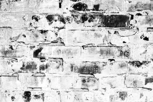 Texture d'un mur de briques avec des fissures et des rayures qui peuvent être utilisées comme fond — Photo