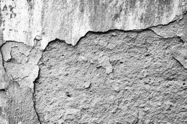 Texture d'un mur en béton avec des fissures et des rayures qui peuvent être utilisées comme fond — Photo