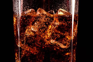 Cola glass with ice cubes and droplets, isolated on black background  clipart