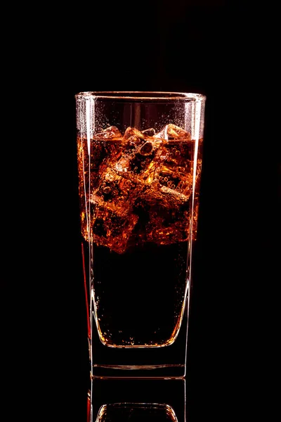 Cola glass with ice cubes and droplets, isolated on black background — Stock Photo, Image