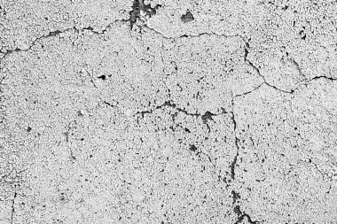 Çatlakları ve çizikleri olan beton bir duvarın dokusu arka plan olarak kullanılabilir.