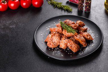 Susamlı tavuk fileto, siyah taş tabakta teriyaki sosu. Asya mutfağı