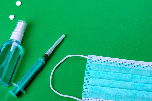 Medical supplies on a colored background as an attribute of the fight against coronavirus. World-wide pandemic, protection