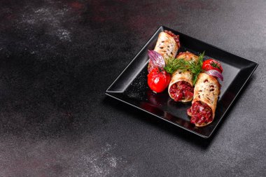 Lezzetli taze et tartartarı ve siyah bir tabakta siyah bir arka planda kızarmış ekmek.