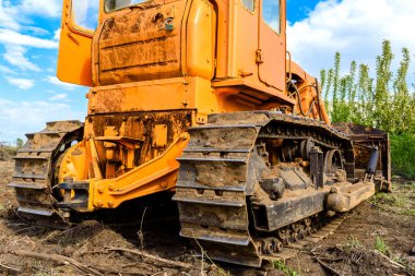 Endüstriyel inşaat alanı buldozer otoyol inşaatı sırasında toprağı düzleştiriyor ve hareket ettiriyor. İğrenç bir şantiyede sarı buldozer.