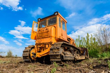 Endüstriyel inşaat alanı buldozer otoyol inşaatı sırasında toprağı düzleştiriyor ve hareket ettiriyor. İğrenç bir şantiyede sarı buldozer.