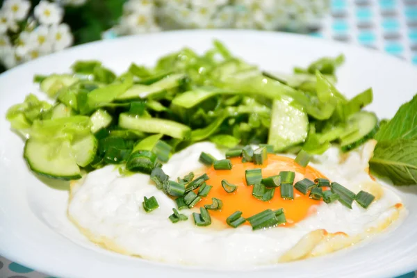 İştah açıcı omlet beyaz tabakta lahana salatası ile