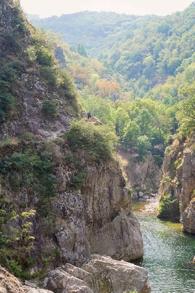 Man climbs a mountain along the river Ardeche