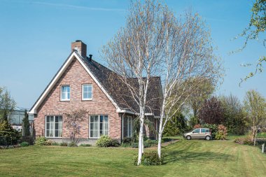 Nootdorp, The Netherlands, April 7, 2019:  Beautiful bungalow situated between huge greenhouses