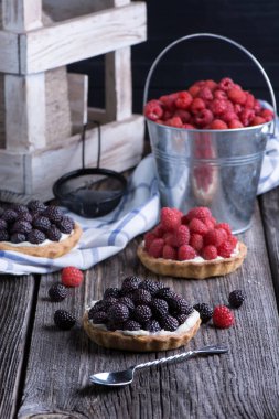 Berry mini turta peçete ve kova ahududu ahşap tablo.