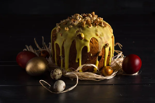 Easter cake covered with colored frosting and easter eggs.