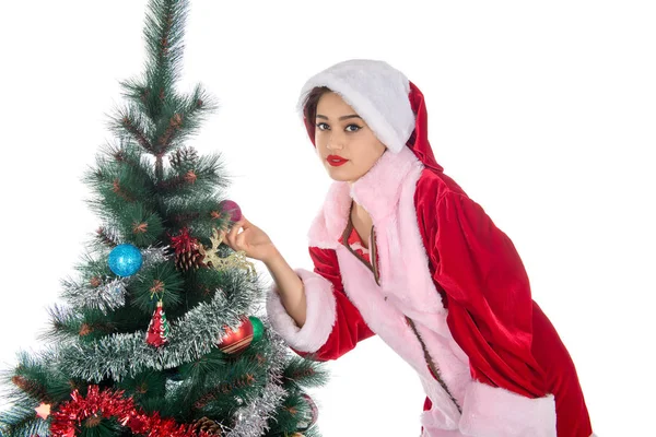 Beautiful sexy blonde girl in a Christmas costume at a Christmas tree — Stock Photo, Image