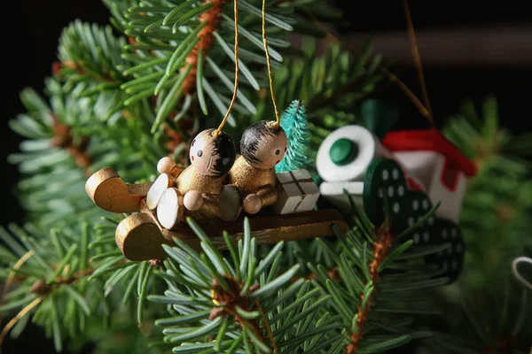 Christmas toy  on a branch. White wooden background. free space — Stock Photo, Image