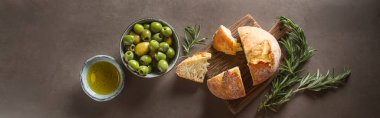 Olivier petrol taze otlar ve ekmek. Gri arka plan. İtalyanca
