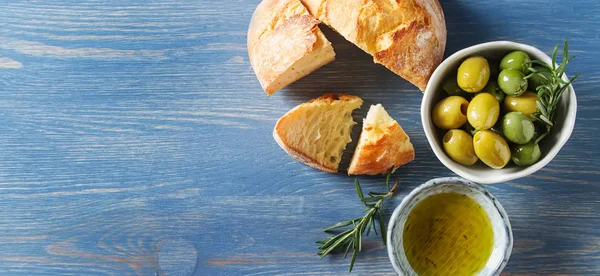 Olivier olaj a friss fűszernövények és a kenyér. Kék háttér. olasz — Stock Fotó
