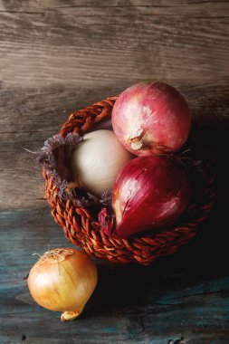 Soğan farklı çeşitleri ve renkler. Koyu gri arka plan.