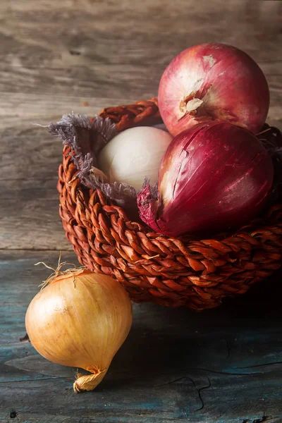 Cebolas de diferentes variedades e cores. Fundo cinza escuro . — Fotografia de Stock