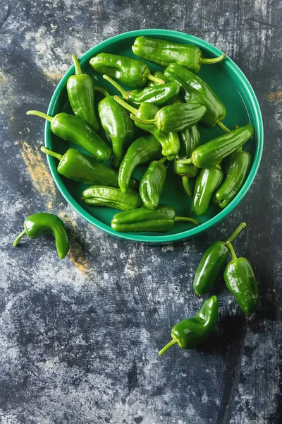 Green, fresh jalapeno peppers. Spicy Mexican food. Dark backgrou