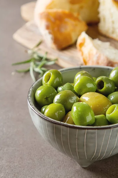 Olivier oil with fresh herbs and bread. Gray background. Italian — Stock Photo, Image