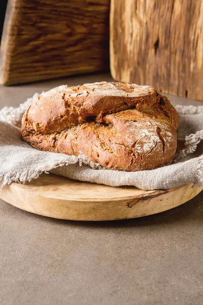 Fresh homemade French black bread. Dark background. — Stock Photo, Image