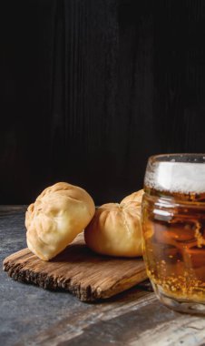 Geleneksel Rus etli börek, (belyashi) bira ile. Karanlık backgro