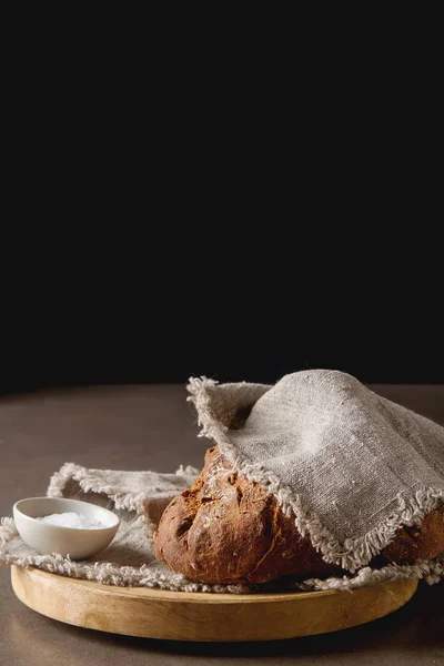 Fresh homemade French black bread. Dark background. — Stock Photo, Image