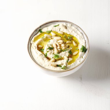 Vintage bir seramik kase otlar, zeytin yağı ile klasik humus. 