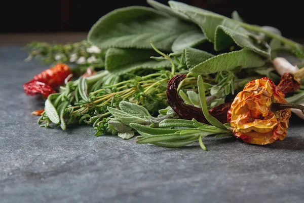 Mix of fresh Italian herbs from garden on an old table. Rosemary