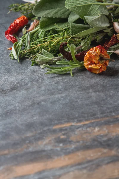 Mix of fresh Italian herbs from garden on an old table. Rosemary