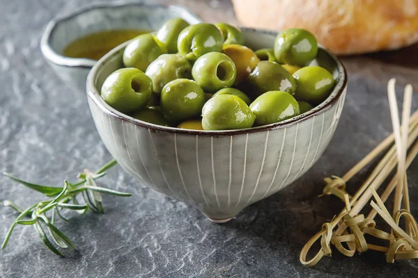 Olivier oil with fresh herbs and bread. Gray background. Italian — Stock Photo, Image