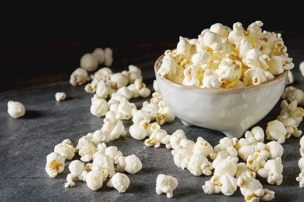 Salted popcorn in a cup. Dark background. Selective focus. Fast — Stock Photo, Image