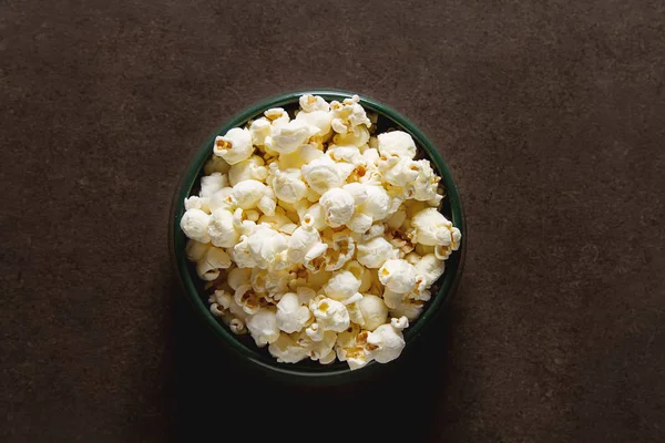 Salted popcorn in a cup. Dark background. Selective focus. Fast — Stock Photo, Image