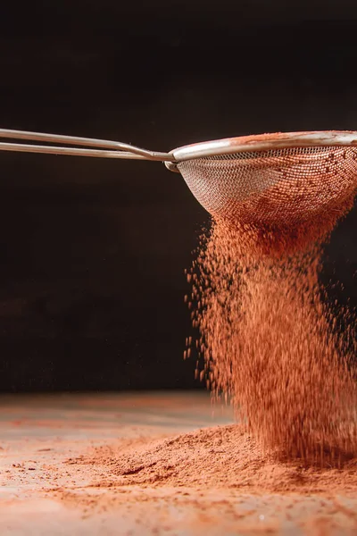 Natural cocoa powder in a sieve for chocolate and baking. Copy s — Stock Photo, Image