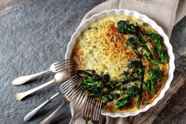 Vegetable quiche with broccoli and cheese in a white plate. Trad clipart