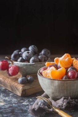 Mandarin, üzüm, yaban mersini meyve salatası ile plaka. Lezzetli 