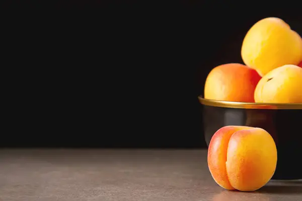 stock image Ripe apricots in a bowl. Dark background. Food for a vegan and a