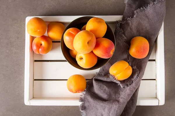 Olgun kayısı bir kase. Koyu arka plan. Bir vegan yemek ve bir