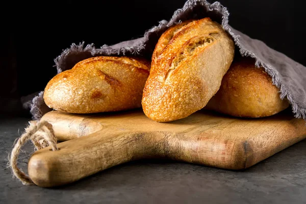 Homemade Italian bread. Fresh bakery. Dark background. — Stock Photo, Image