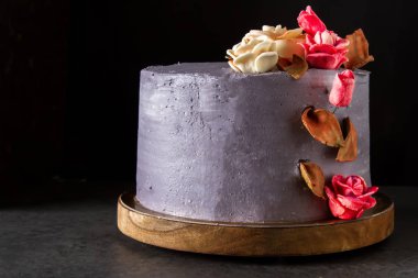 Çikolatalı pasta doğum günü için çiçekli. Koyu arka plan.