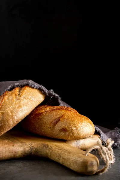 Homemade Italian bread. Fresh bakery. Dark background.