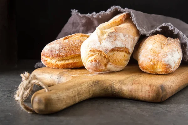 Homemade Italian bread. Fresh bakery. Dark background.