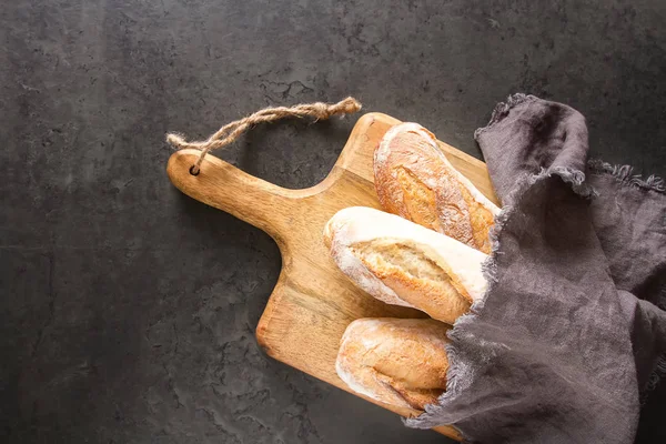 Homemade Italian bread. Fresh bakery. Dark background.