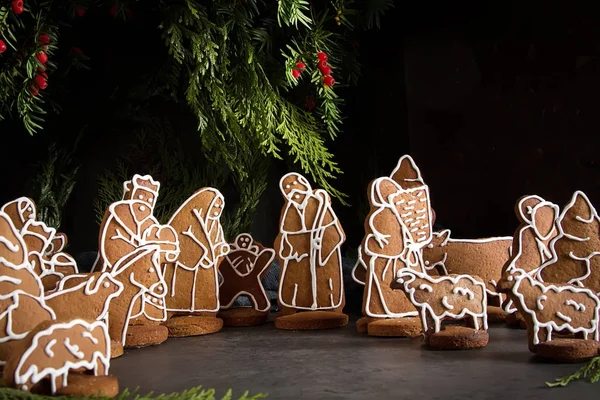 Christmas Betlem decoration, gingerbread. The Birth of Christ. Dark background